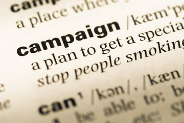 Obraz premium Close up of old English dictionary page with word campaign