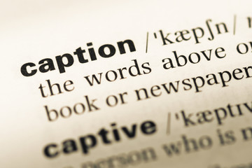 Close up of old English dictionary page with word caption