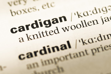 Fototapeta premium Close up of old English dictionary page with word cardigan