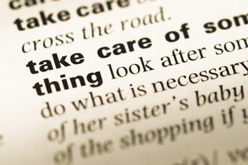 Obraz premium Close up of old English dictionary page with word take care of