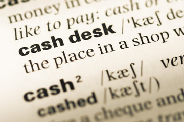 Fototapeta premium Close up of old English dictionary page with word cash desk