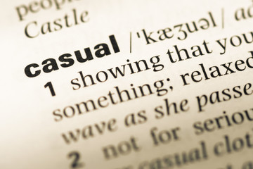 Obraz premium Close up of old English dictionary page with word casual