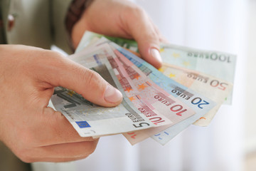 Male hands holding euros closeup