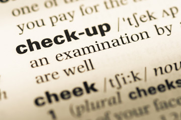 Obraz premium Close up of old English dictionary page with word check up