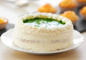 Fresh homemade cake layered on a white plate.