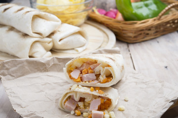Fototapeta na wymiar Breakfast burrito with eggs, cheddar, microgreens and roasted mu