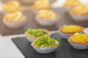 Fresh homemade fruit tarts with citruses and kiwi