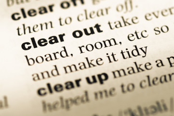 Obraz premium Close up of old English dictionary page with word clear out