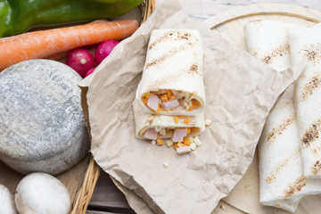 Breakfast burrito with eggs, cheddar, microgreens and roasted mu