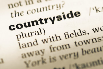 Obraz premium Close up of old English dictionary page with word countryside