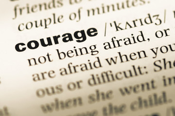 Close up of old English dictionary page with word courage