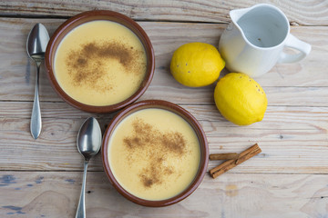 Traditional creme brulee on ceramic dish on wooden table