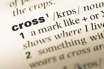 Obraz premium Close up of old English dictionary page with word cross
