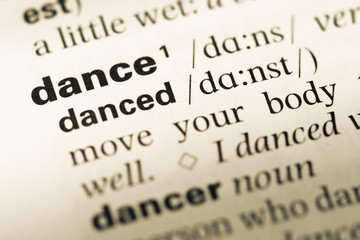 Fototapeta premium Close up of old English dictionary page with word dance