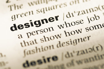 Fototapeta premium Close up of old English dictionary page with word designer