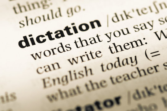 Close up of old English dictionary page with word dictation