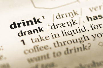 Obraz premium Close up of old English dictionary page with word drink