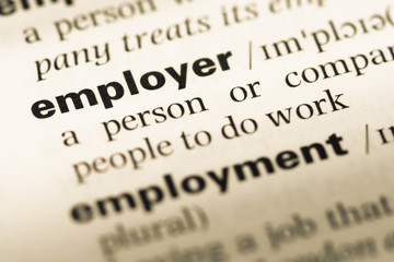 Fototapeta premium Close up of old English dictionary page with word employer