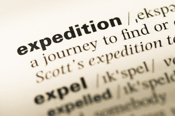 Close up of old English dictionary page with word expedition