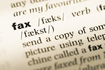 Fototapeta premium Close up of old English dictionary page with word fax