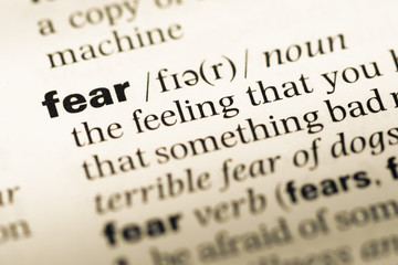 Close up of old English dictionary page with word fear