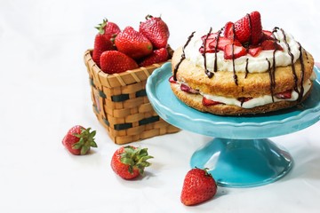 Strawberry Shortcake with fresh strawberries whipped frosting and chocolate drizzle