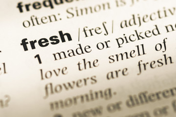 Obraz premium Close up of old English dictionary page with word fresh