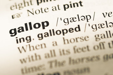 Close up of old English dictionary page with word gallop