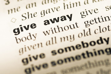 Obraz premium Close up of old English dictionary page with word give away