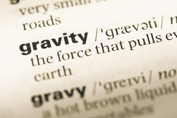 Close up of old English dictionary page with word gravity
