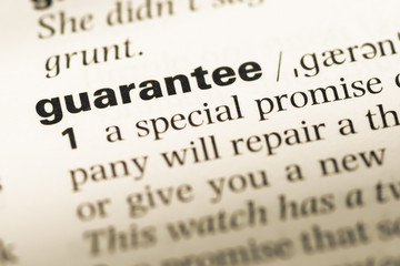 Close up of old English dictionary page with word guarantee