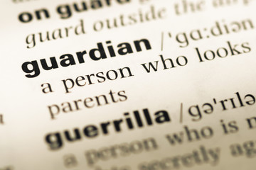 Obraz premium Close up of old English dictionary page with word guardian