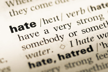 Close up of old English dictionary page with word hate