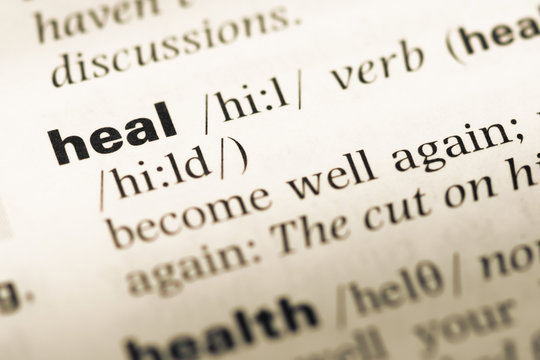 Close up of old English dictionary page with word heal