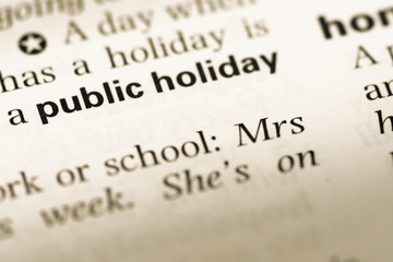 Close up of old English dictionary page with word public holiday