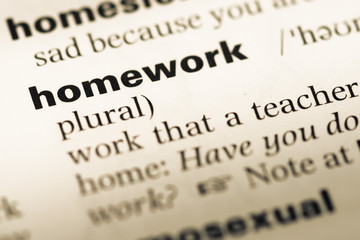 Obraz premium Close up of old English dictionary page with word homework
