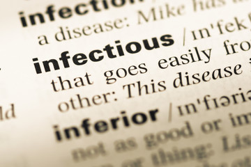 Close up of old English dictionary page with word infectious