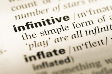 Close up of old English dictionary page with word infinitive