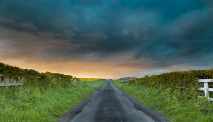 Spring Shower Clouds Above Empty British Countryside Road