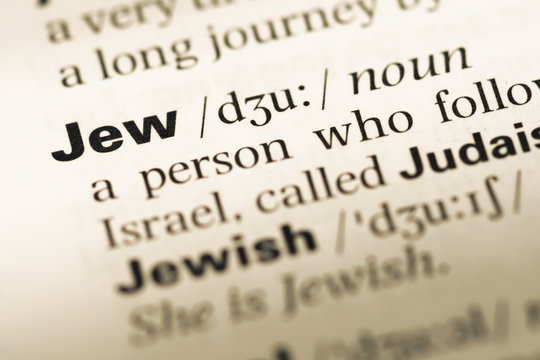 Close up of old English dictionary page with word jew