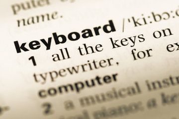 Obraz premium Close up of old English dictionary page with word keyboard