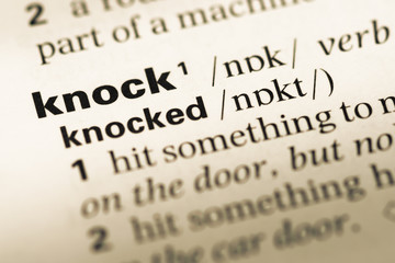 Obraz premium Close up of old English dictionary page with word knock