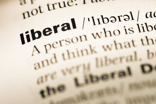 Close up of old English dictionary page with word liberal