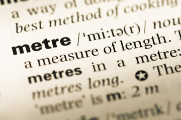 Fototapeta premium Close up of old English dictionary page with word metre