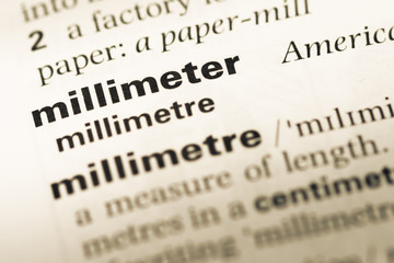 Close up of old English dictionary page with word millimeter