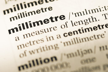 Close up of old English dictionary page with word millimetre
