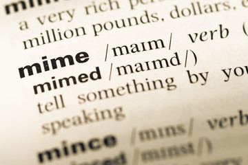 Close up of old English dictionary page with word mime