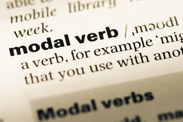 Close up of old English dictionary page with word modal verb