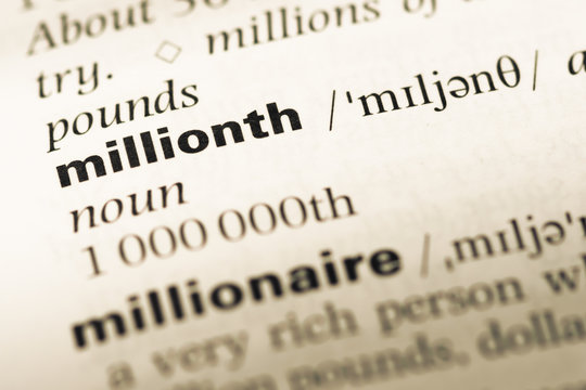 Close up of old English dictionary page with word millionth