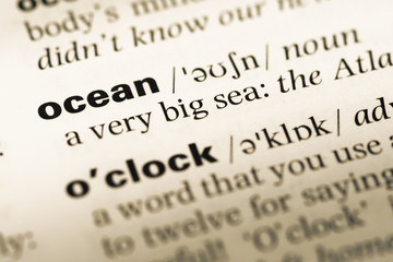 Fototapeta premium Close up of old English dictionary page with word ocean